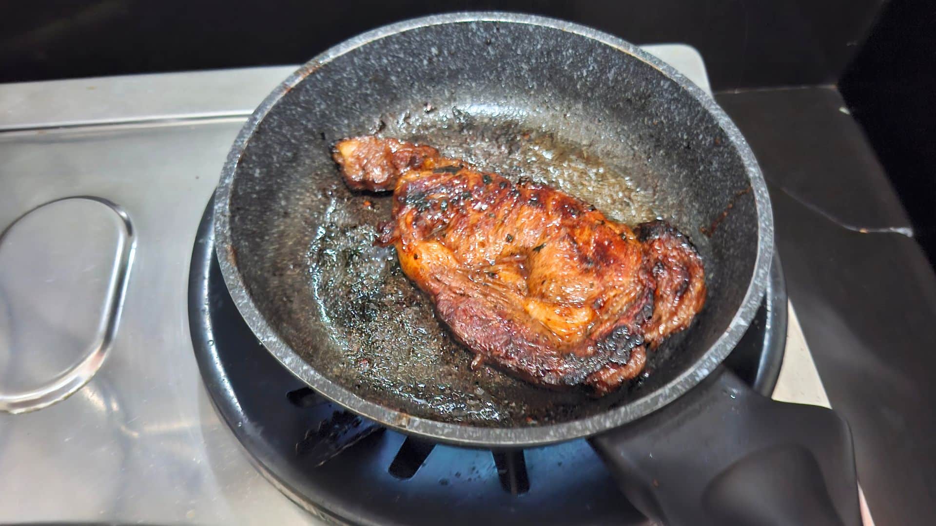 Flipping the steak for Sweet and Spicy Marinade Steak recipe